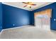 Bedroom with ceiling fan and sliding glass doors at 1221 Glendora N Rd, Kissimmee, FL 34759