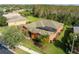 Aerial view of a terracotta-colored home featuring a screened-in pool and well-manicured landscaping at 1221 Glendora N Rd, Kissimmee, FL 34759