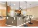 Bright eat-in kitchen features stainless steel appliances, dark countertops, and pendant lighting over the breakfast bar at 1221 Glendora N Rd, Kissimmee, FL 34759