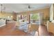 Bright living room featuring wood floors, modern decor, large windows, and access to the outdoor patio at 1221 Glendora N Rd, Kissimmee, FL 34759