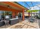 Spacious, screened-in patio features both dining and lounge furniture, a ceiling fan, and backyard views at 1221 Glendora N Rd, Kissimmee, FL 34759