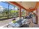 Screened outdoor patio with views of lush greenery, featuring comfortable seating and dining areas for relaxation at 1221 Glendora N Rd, Kissimmee, FL 34759