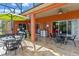 Inviting outdoor patio with multiple seating areas, umbrella, and stylish decor, perfect for entertaining guests at 1221 Glendora N Rd, Kissimmee, FL 34759