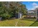 Spacious backyard featuring a shed and a view of the screened pool area at 1533 Findlay St, Deltona, FL 32725