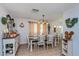 Cozy dining room with rustic wood table, white chairs, decorative shelving and accents at 1533 Findlay St, Deltona, FL 32725