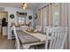 Charming dining room with long table, white chairs, and decorative wall art at 1533 Findlay St, Deltona, FL 32725