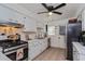 Classic kitchen with white cabinets, stainless steel appliances and a practical layout at 1533 Findlay St, Deltona, FL 32725