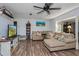 Inviting living room with a comfortable sectional sofa, fan and view into dining area at 1533 Findlay St, Deltona, FL 32725