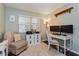 Bright home office featuring a white desk, dual monitors, and comfortable seating near a window at 1533 Findlay St, Deltona, FL 32725