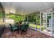 Screened-in patio with brick floors and dining set, perfect for outdoor entertaining at 1533 Findlay St, Deltona, FL 32725