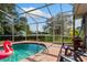 Inviting pool area with a screened enclosure and comfortable seating at 1533 Findlay St, Deltona, FL 32725