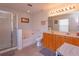 Elegant bathroom with double sinks, a soaking tub, and a walk-in shower at 315 Aldridge Ln, Davenport, FL 33897
