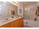 Well-lit bathroom with double sinks and a shower/tub combo at 315 Aldridge Ln, Davenport, FL 33897