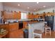 Modern kitchen with wood cabinets, a breakfast bar, and black appliances at 315 Aldridge Ln, Davenport, FL 33897