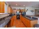 Bright kitchen with wood cabinets, stainless steel appliances, and tile flooring at 315 Aldridge Ln, Davenport, FL 33897