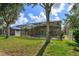 Relaxing pool and patio area with a screened enclosure at 315 Aldridge Ln, Davenport, FL 33897