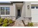 Front entrance with stone accents and a black door at 3161 Indian Trl, Eustis, FL 32726