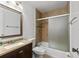 Bathroom with granite vanity, tiled shower, decorative tile accents, and updated fixtures at 3390 Cedar Spring Pl # 163, Winter Park, FL 32792