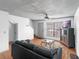 Cozy living room featuring a comfortable sofa, ceiling fan, and a large window for natural light at 3390 Cedar Spring Pl # 163, Winter Park, FL 32792