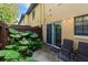 Private patio area with chairs and lush landscaping at 3390 Cedar Spring Pl # 163, Winter Park, FL 32792