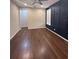 Bedroom with wood floors and blue accent wall at 360 Red Rose Ln, Sanford, FL 32771