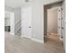 The view showcases a hall with light tile flooring and a half bathroom with toilet and vanity at 5015 Railroad Vine Aly, Winter Garden, FL 34787