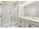 A bathroom featuring a double sink vanity and glass enclosed shower with white tile surround at 5015 Railroad Vine Aly, Winter Garden, FL 34787