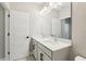 This bathroom features dual sinks with quartz countertops, modern lighting, and gray cabinets at 5015 Railroad Vine Aly, Winter Garden, FL 34787