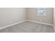 A bedroom featuring neutral walls and carpeted floors with a single window at 5015 Railroad Vine Aly, Winter Garden, FL 34787