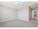 Large bedroom with plush carpet and doorway to bathroom at 5015 Railroad Vine Aly, Winter Garden, FL 34787