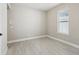 The room features light wood floors, neutral walls, and a window with blinds at 5015 Railroad Vine Aly, Winter Garden, FL 34787