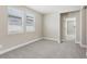 A bedroom with neutral walls, carpet floors, and a view to another room at 5015 Railroad Vine Aly, Winter Garden, FL 34787