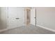A bedroom featuring neutral walls and carpeted floors with double closets and doorway at 5015 Railroad Vine Aly, Winter Garden, FL 34787