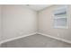 A bedroom featuring neutral walls and carpeted floors with a single window at 5015 Railroad Vine Aly, Winter Garden, FL 34787