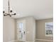 Bright dining area featuring elegant lighting and a view of the outdoors through a glass door at 5015 Railroad Vine Aly, Winter Garden, FL 34787