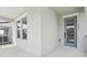 Covered front porch showcases a modern entrance with a blue glass door and contemporary railing at 5015 Railroad Vine Aly, Winter Garden, FL 34787