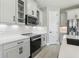Bright kitchen with stainless steel appliances, white cabinets and subway tile backsplash at 5015 Railroad Vine Aly, Winter Garden, FL 34787