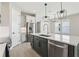 Modern kitchen with island, stainless appliances, pendant lights, and an open layout at 5015 Railroad Vine Aly, Winter Garden, FL 34787