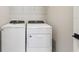 A laundry room featuring a white Whirlpool washer and dryer set at 5015 Railroad Vine Aly, Winter Garden, FL 34787