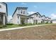 Street view of attractive two-story homes with modern design, covered porches, and manicured landscaping at 5015 Railroad Vine Aly, Winter Garden, FL 34787