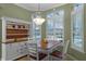 Bright breakfast nook featuring a dining table, hutch, and ample natural light from the windows at 8407 River Branch Pl, Sanford, FL 32771
