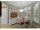 Sunny breakfast nook with a dining table, hutch, and windows with plantation shutters at 8407 River Branch Pl, Sanford, FL 32771