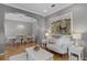 Inviting living room with hardwood floors, elegant white furniture, and a view into the dining room at 8407 River Branch Pl, Sanford, FL 32771