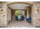 Charming covered patio area with stone columns and comfortable seating, perfect for relaxing outdoors at 8407 River Branch Pl, Sanford, FL 32771