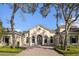 Stunning home with arched entryway, brick driveway, tile roof, and lush landscaping at 8681 Crested Eagle Pl, Sanford, FL 32771