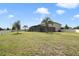 Large backyard featuring a screened pool area, grassy lawn, and privacy fence at 3303 Kayak Way, Orlando, FL 32820