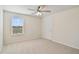 This bedroom features carpet, white walls, a ceiling fan, and a window at 3303 Kayak Way, Orlando, FL 32820