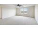 Spacious bedroom with large carpet, natural light from large windows, and a ceiling fan at 3303 Kayak Way, Orlando, FL 32820