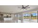 Open-concept living area with tile flooring, kitchen view, and backyard access at 3303 Kayak Way, Orlando, FL 32820