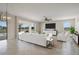 Living room featuring white furniture, modern ceiling fan, large windows with a view to the pool and patio at 3303 Kayak Way, Orlando, FL 32820